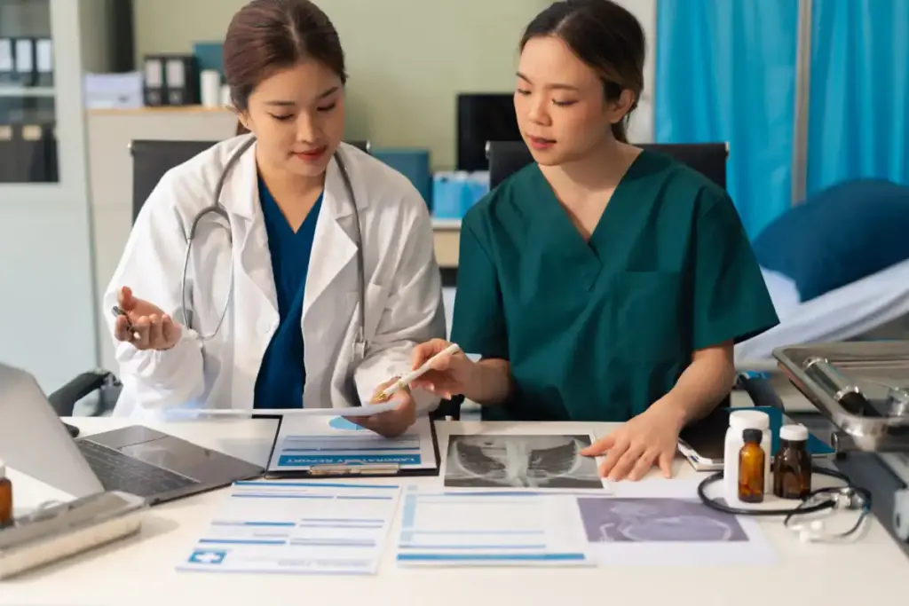 Duas jovens médicas analisando exames e prontuários de pacientes